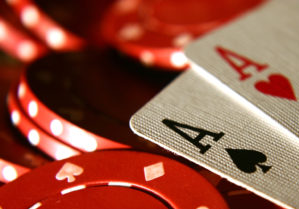 Closeup of two playing cards; aces on top of poker chips
