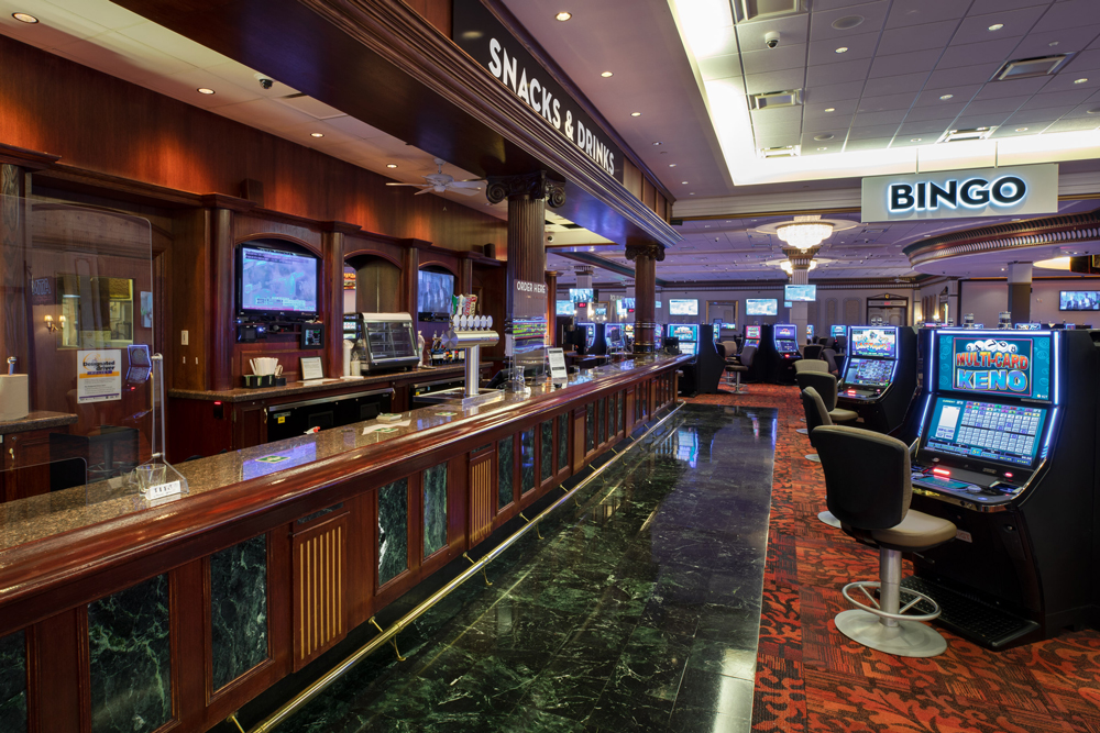 Snacks and Drinks dining long bar top with slot machines across in the McPhillips Station Casino