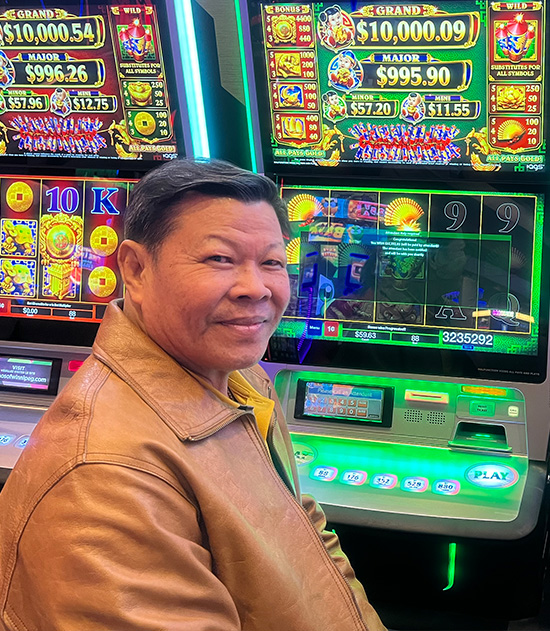 jackpot winner in front of a slot machine