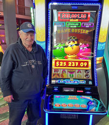 Jackpot winner standing by slot machine