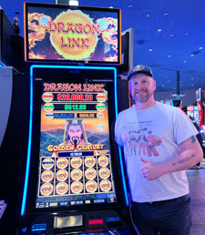 Jackpot winner standing by slot machine